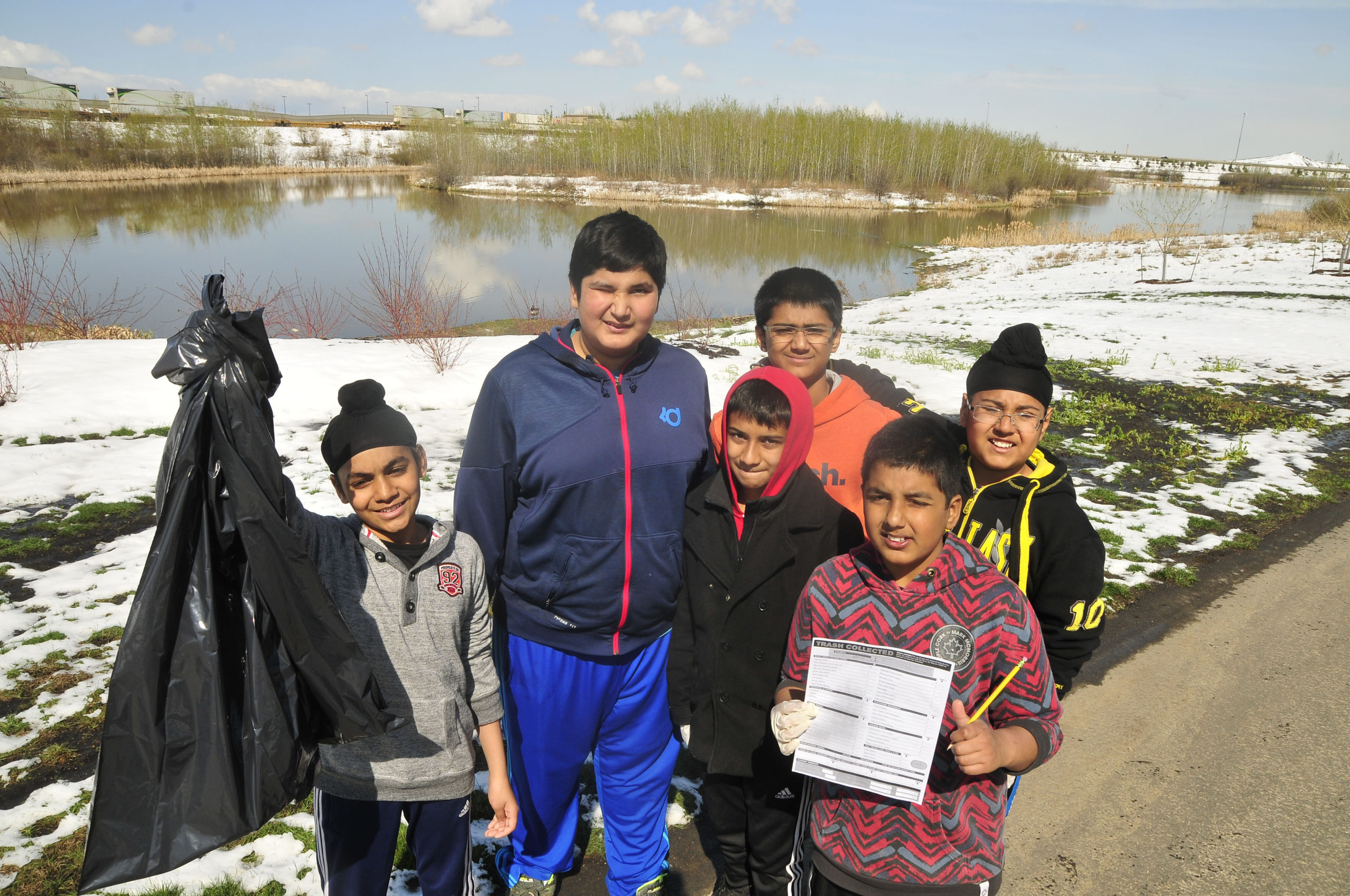 Students helping out with their own schoolyard cleanup in Fulton Creek, Edmonton.